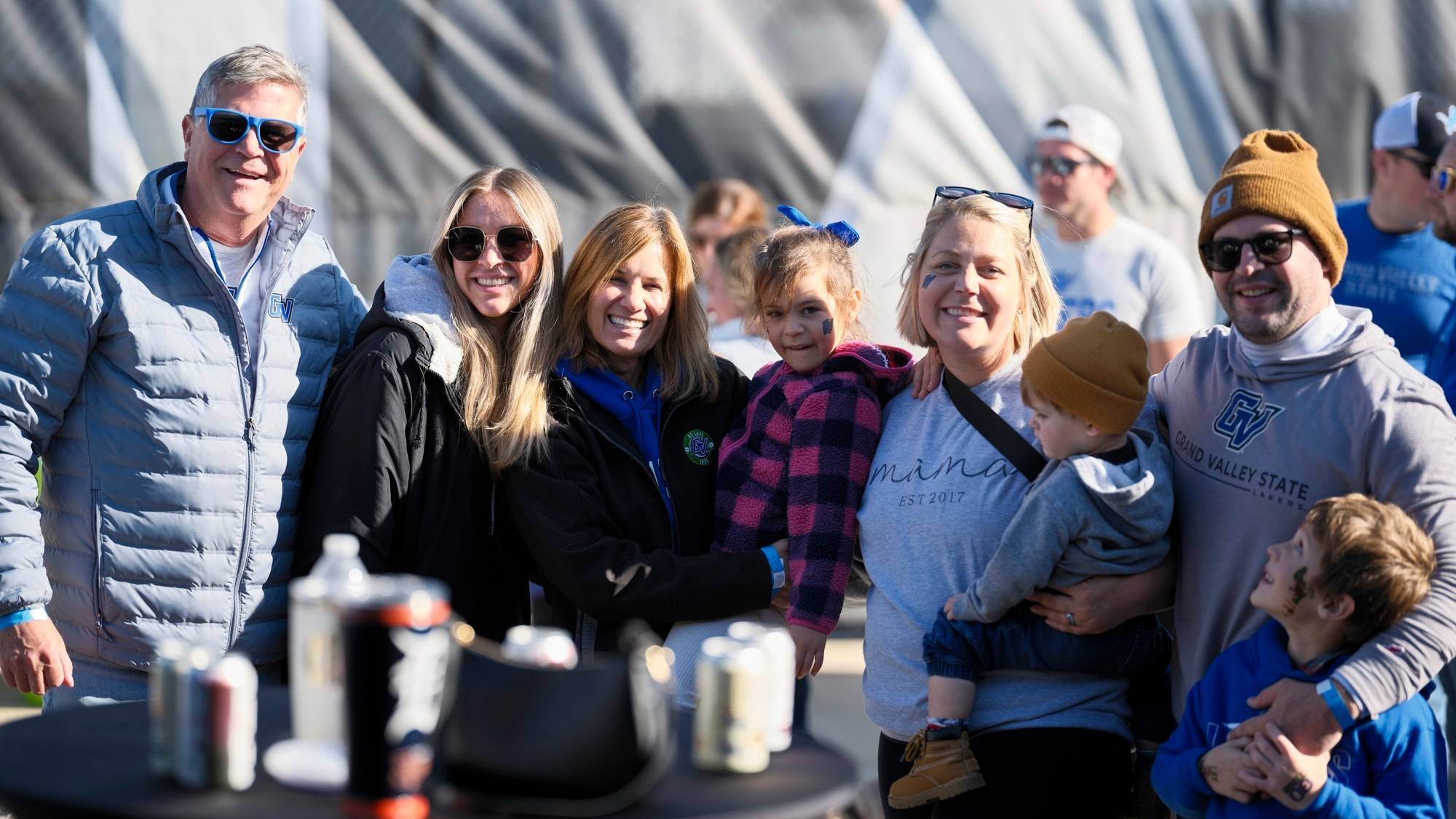 A group of family and friends smile at the 2024 tailgate